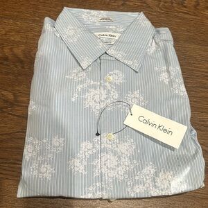 New Calvin Klein men’s collared shirt. Blue stripe with design. Size L.